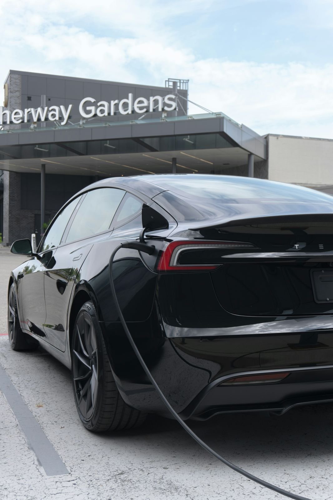 Tesla electric vehicle connected to a charger in Etobicoke, Ontario, in 2024